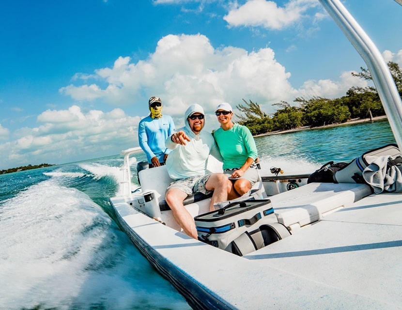 Guide with woman on boat to fly fish in the flats