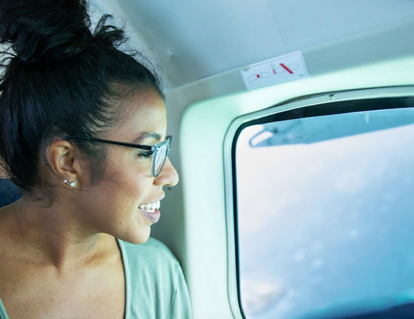 Woman in airplane flying over the Great Blue Hole