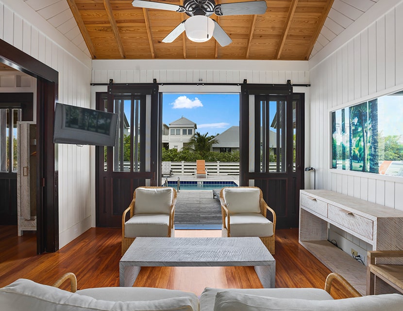 Living room opening up onto private plunge pool at the Family Cottage with pool property at Mahogany Bay Resort & Beach Club