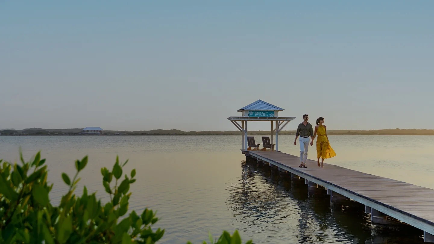 Guest couple on the dock at Mahogany Bay Resort San Pedro Ambergris Caye Belize 1