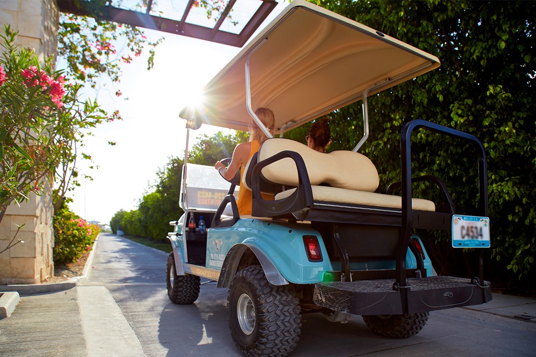 Golf cart driving through Mahogany Bay Resort & Beach Club