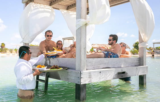 Overwater cabana service at the beach club